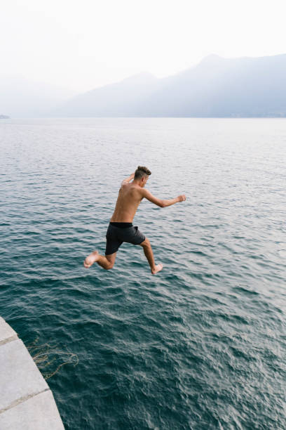 istock Jump in the water, Young man diving 677393494