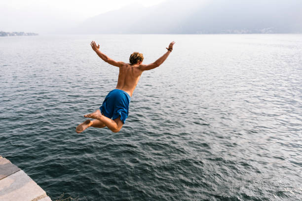 istock Brave man jump diving in the water. 677393636