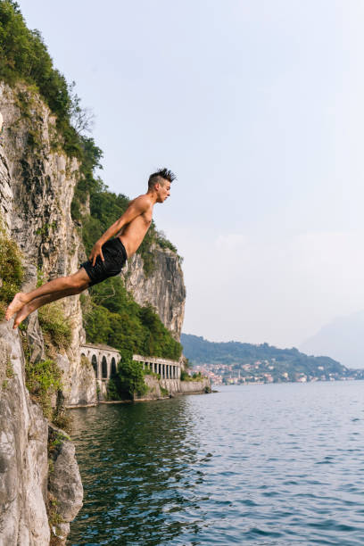 istock Jump in the water, Young man diving 677393660