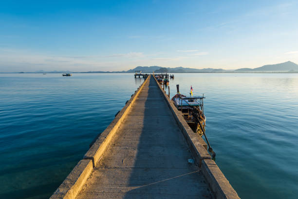 istock Ship boat dock at calm sea blue water and sky 677398982