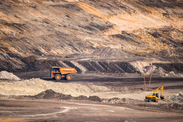 istock Part of a coal mine pit with big mining truck working 677427562