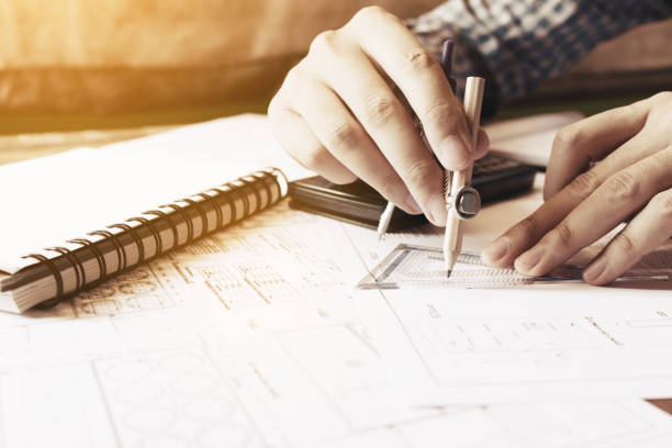 istock Architect man drawing geometric shape on sheet of paper at office table. 677433574