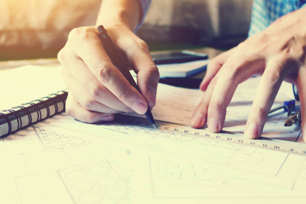 istock Architect man drawing geometric shape on sheet of paper at office table. 677452718
