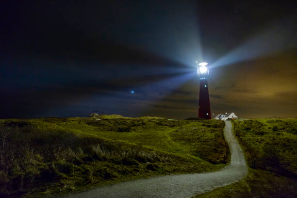faro en la noche en la isla schiermonnikoog en los países bajos - lighthouse beacon north sea coastal feature fotografías e imágenes de stock