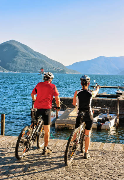 people riding bicycles at promenade in ascona ticino switzerland - tessin imagens e fotografias de stock