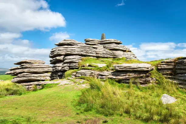 View of Bellever Tor in Dartmoor national park in southwest England. Copy space in blue sky.