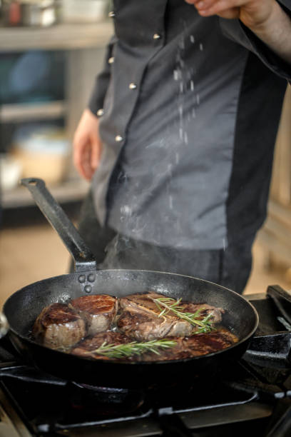 istock Chef putting salt for cooking meat 677467350