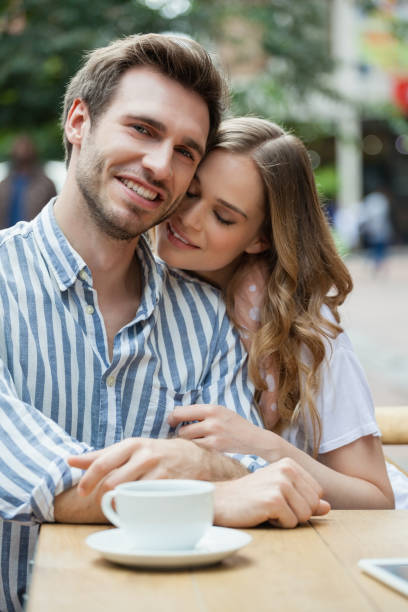 istock Happy romantic couple sitting at sidewalk cafe 677469048