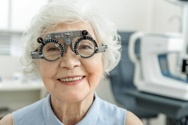 istock Hilarious smiling old female person checking eyesight 677477570
