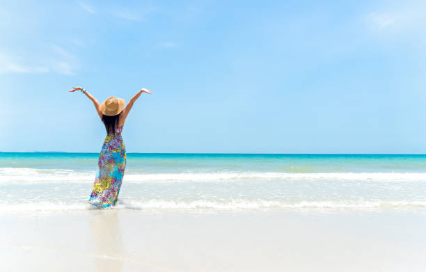istock Happy woman on the beach in summer 677482312