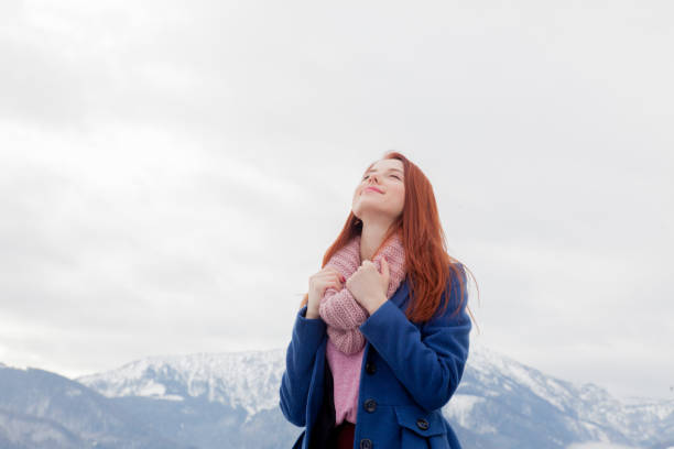 istock beautiful young woman on the mountains background 677492500