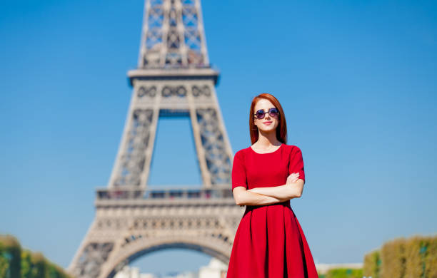 istock beautiful young woman on the Eiffel Tower background 677492972