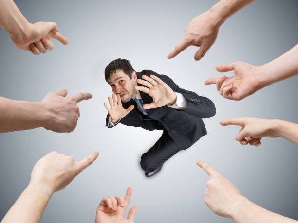 istock Many hands are pointing and blame stressed man. View from above. 677500516
