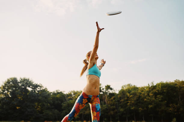 istock Young athletic girl playing with flying disc, ultimate 677502476