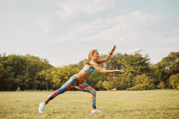 istock Young athletic girl playing with flying disc, ultimate 677502664