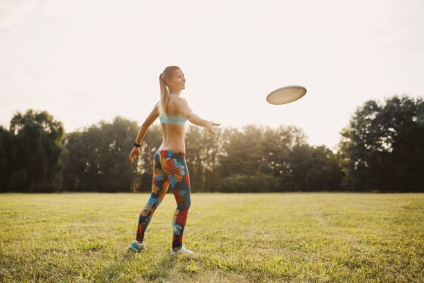 istock Young athletic girl playing with flying disc, ultimate 677503324