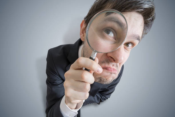 istock Young businessman is looking through magnifying glass. View from above. 677506574