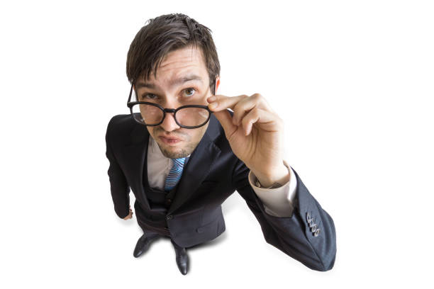 istock Young suspicious man is looking at you. View from top. Isolated on white background. 677507436