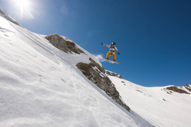 istock Man with snowboard jumping in midair while riding off piste 677511724