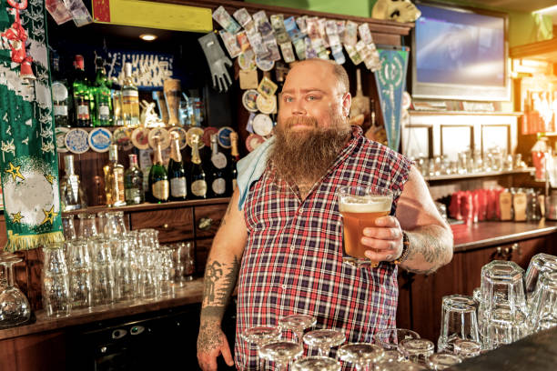 istock Happy bearded male tasting beverage in pub 677513908