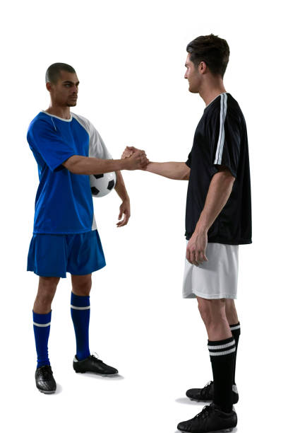 istock Two football players shaking hands 677520274