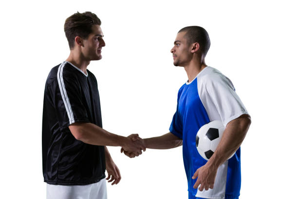 istock Two football players shaking hands 677520392