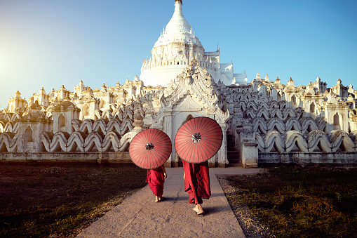 Novices under umbrellas at historic temple, Mingun, Mandalay, Myanmar