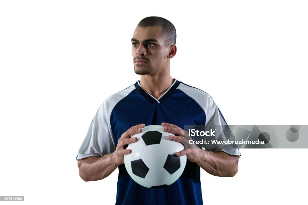 Football Player Holding Football With Both Hands Stock Photo