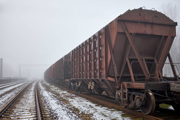 istock Freight train with hopper cars in the fog 677531402