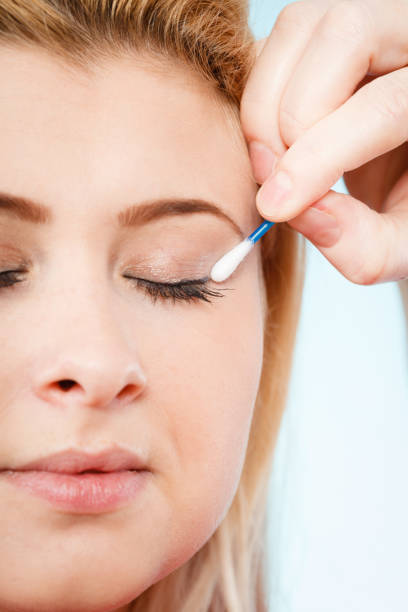 istock Woman getting her makeup done with cotton buds 677534182