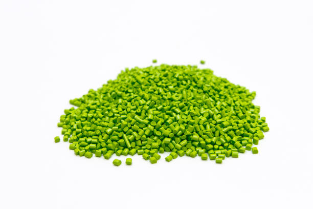istock Green plastic pellets on a white background. Polymeric dye for plastics. 677583386