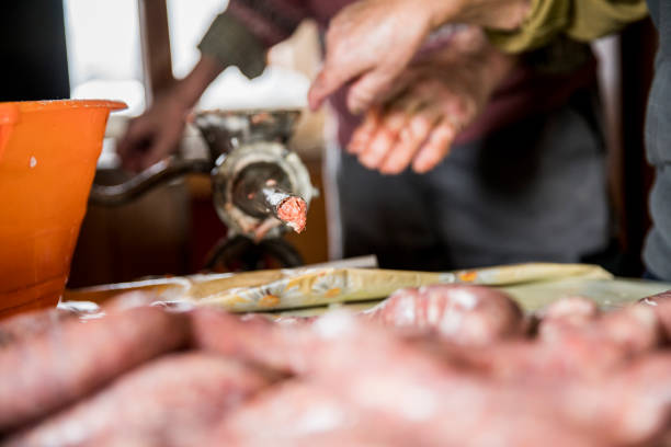 istock Elderly couple producing sausages at home 677596342