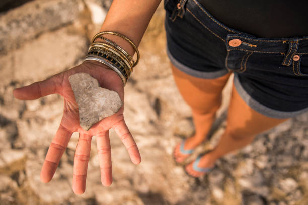 istock Woman holding a heart shaped stone 677600416