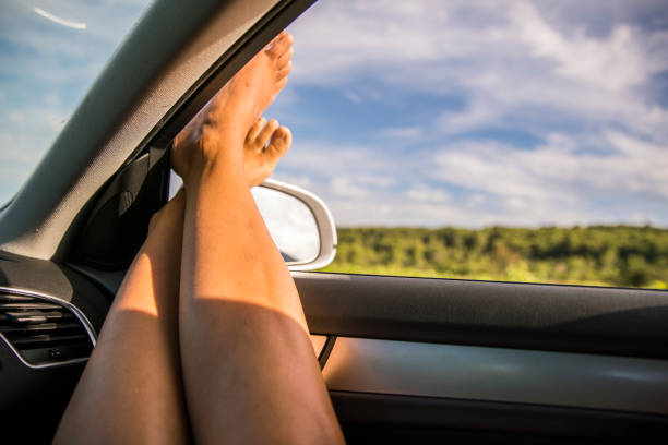 istock Woman's feet dangling out of a car 677600518