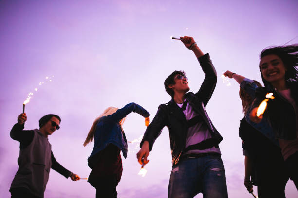 istock Excited group of young friends being silly with fireworks 677609662