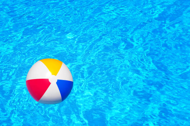 istock Colorful inflatable ball floating in swimming pool 677636972