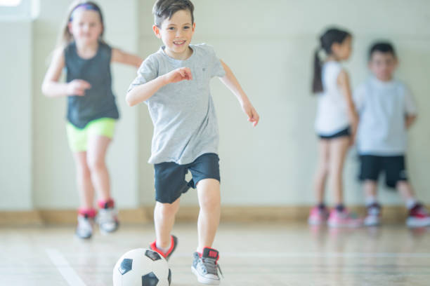 partita di calcio - soccer child indoors little boys foto e immagini stock