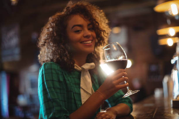 istock Woman having wine at bar counter 677676170