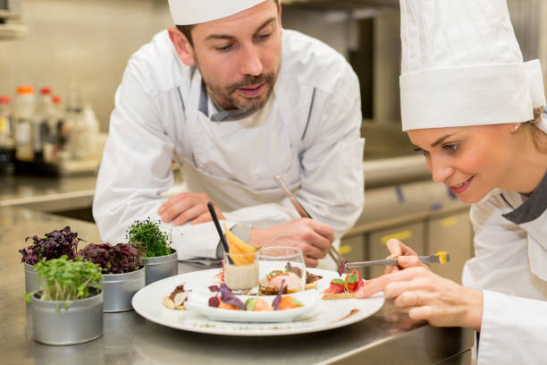 istock cooking class,culinary and food concept- Female cook cooking in kitchen 677687084