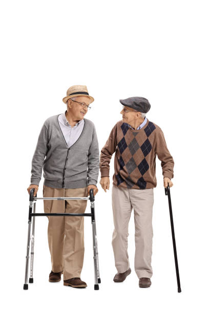 istock Elderly man with walker and another man with cane walking 677699594