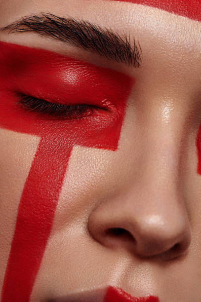 istock Beauty Model with red painted Geometry on Face 677723254