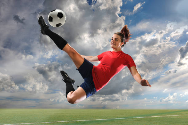 istock Female Soccer Player Kicking Ball 677730638