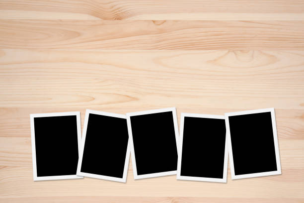istock Blank photos on Wooden Table Background 677732402