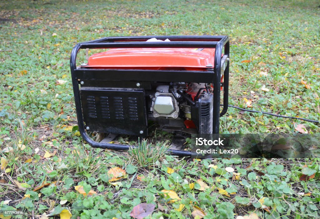 Gasoline Portable Generator. Close up on Mobile Backup Generator in the garden. Standby Generator - Outdoor Power Equipment Generator Stock Photo