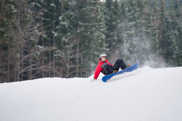 istock Male snowboarder falls on the slopes during the jumping 677747632