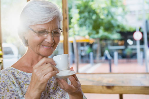 istock Happy senior woman having coffee 677752558