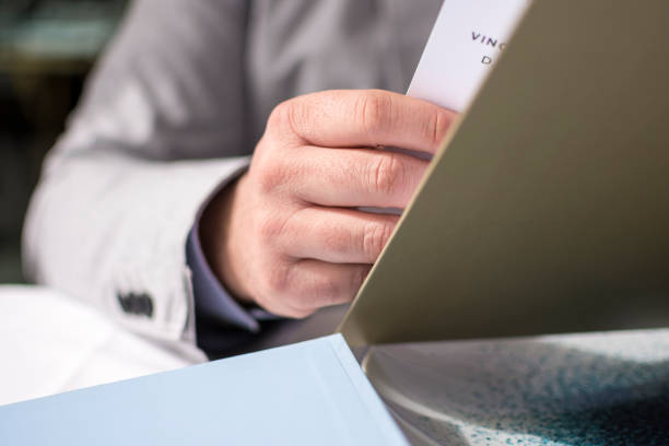 istock Male Hand Holding Restaurant Menu to Make Order for Lunch 677761642