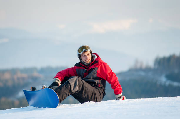 istock Male boarder on his snowboard at winer resort 677764418