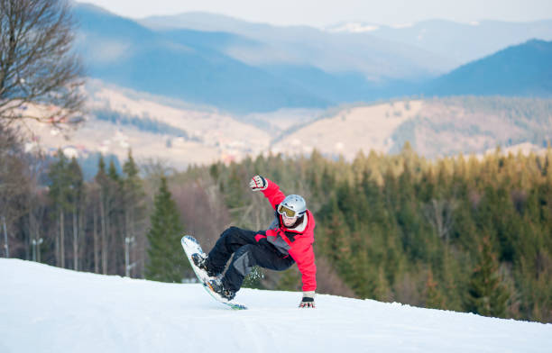istock Male boarder on his snowboard at winer resort 677764420
