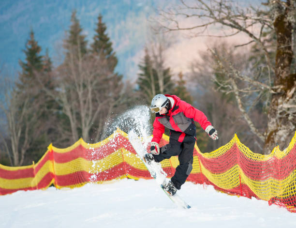 istock Male boarder on his snowboard at winer resort 677764626